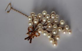 A yellow and white metal brooch, set with thirty pearls each approximately 7mm in diameter,