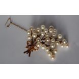 A yellow and white metal brooch, set with thirty pearls each approximately 7mm in diameter,