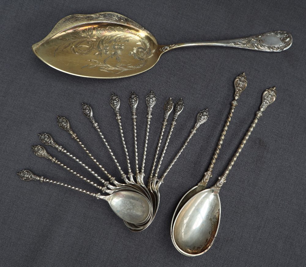 A set of eleven German 800 standard white metal spoons with shield tops and spiral stems together