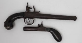 A flintlock cannon barrel pistol, in steel, the hammer striking at the centre, with a walnut stock,