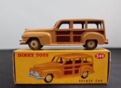 A Dinky Toys diecast model of an Estate Car, with a tan and brown panelled body and cream hubs, No.
