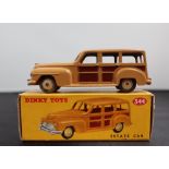 A Dinky Toys diecast model of an Estate Car, with a tan and brown panelled body and cream hubs, No.
