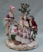 A 19th century Berlin porcelain figure group, depicting a family scene with a toddler,