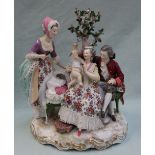 A 19th century Berlin porcelain figure group, depicting a family scene with a toddler,