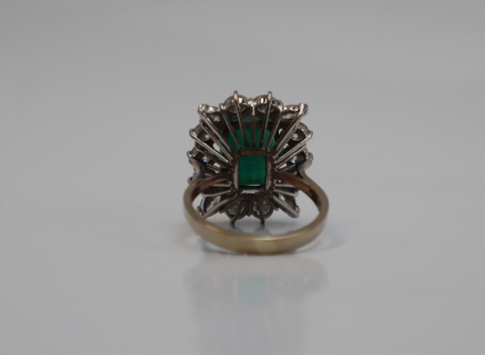 An emerald and diamond cluster ring, the central emerald cut emerald approximately 12mm x 9mm, - Image 6 of 7