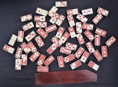 A set of fifty four bone and ebony dominoes,