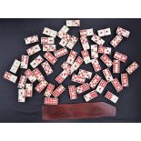 A set of fifty four bone and ebony dominoes,