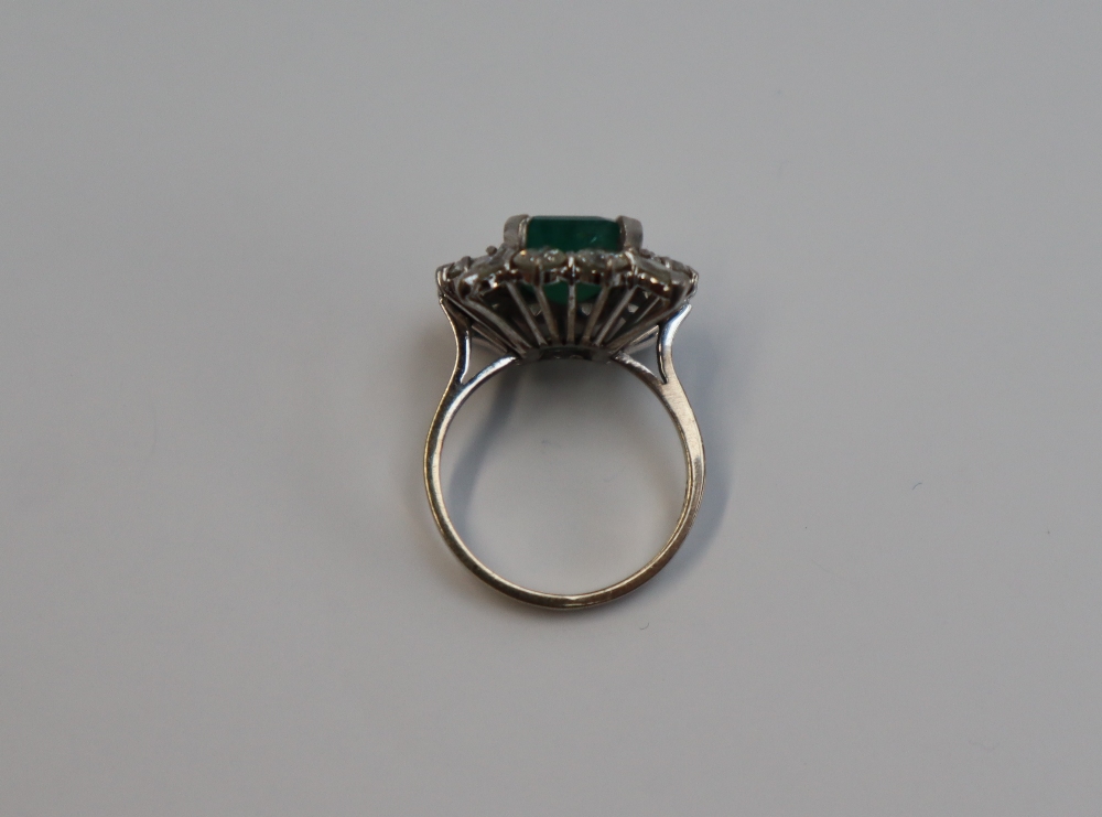 An emerald and diamond cluster ring, the central emerald cut emerald approximately 12mm x 9mm, - Image 5 of 7