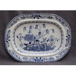 A 19th century blue and white pottery meat plate, decorated in the elephant and rock pattern,