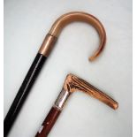A horn handled walking stick with a white metal collar marked Sterling Silver,