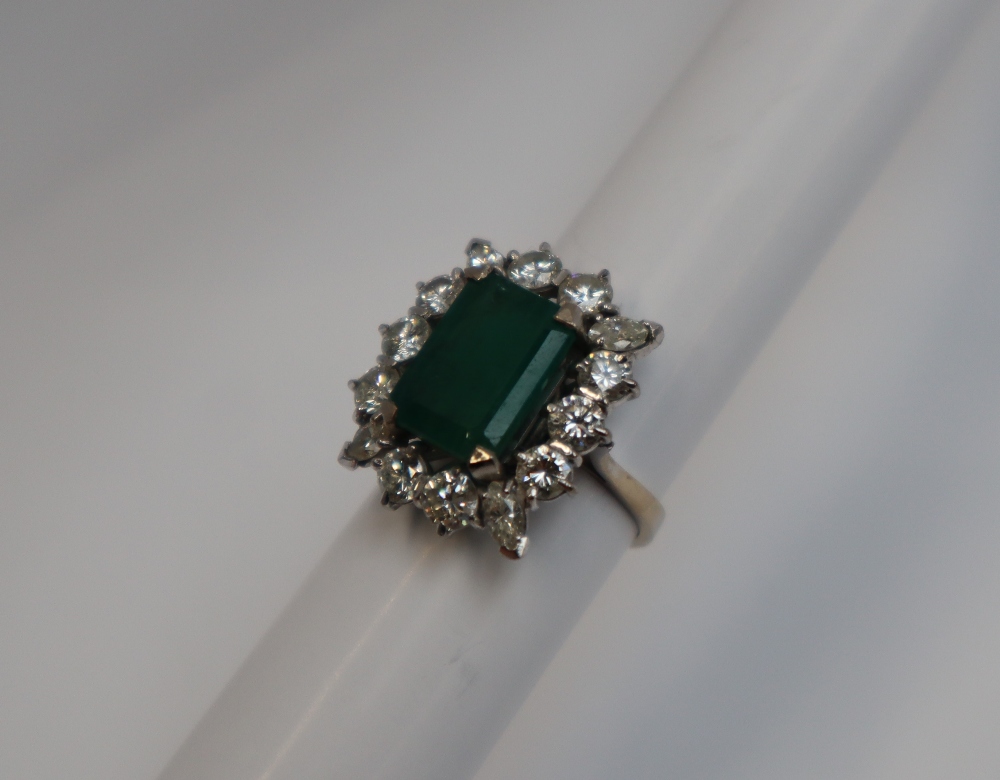 An emerald and diamond cluster ring, the central emerald cut emerald approximately 12mm x 9mm, - Image 3 of 7