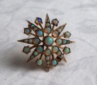 A 9ct yellow gold opal set brooch of star form, approximately 4.