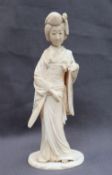 A 19th century Japanese Ivory figure of a geisha, in traditional dress, on an oval base,