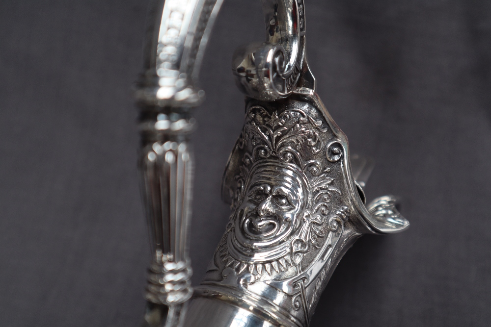 A Victorian silver claret jug, after Cellini, all over decoration of masks and rams, - Image 5 of 13