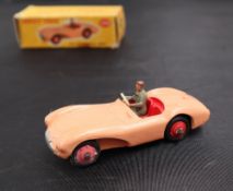 A Dinky Toys diecast model of an Aston Martin DB35, with a salmon pink body, red hubs,