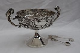 An Edward VII silver pedestal dish the border embossed with dogs and swans with flowerheads and