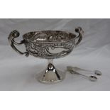 An Edward VII silver pedestal dish the border embossed with dogs and swans with flowerheads and