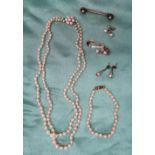 A two strand pearl necklace, with graduated pearls to a 9ct yellow gold pearl set clasp,