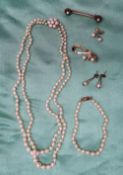 A two strand pearl necklace, with graduated pearls to a 9ct yellow gold pearl set clasp,