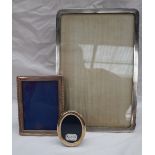 A George V silver photograph frame of rectangular form, with a wave decorated edge, Birmingham,