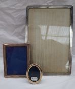 A George V silver photograph frame of rectangular form, with a wave decorated edge, Birmingham,