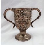 A George III silver twin handled trophy cup, embossed with flowers and leaves on a spreading foot,