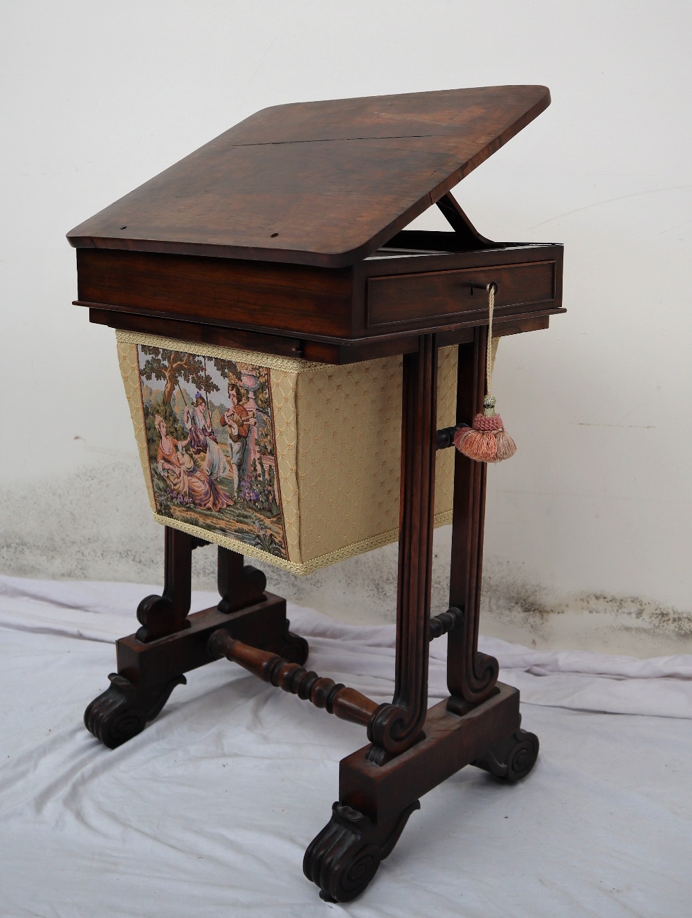 An early Victorian rosewood work table, the hinged top with stay and frieze drawer,