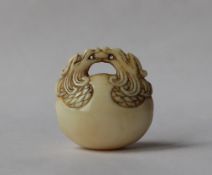 A 19th century Japanese ivory netsuke in the form of a temple bell,