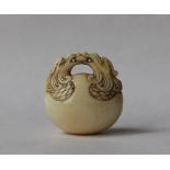 A 19th century Japanese ivory netsuke in the form of a temple bell,