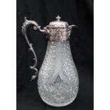 An Edward VII silver and cut glass claret jug, the domed top decorated with flowers and leaves,