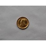 A gold 1/10 Krugerrand dated 1988