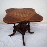 A reproduction mahogany games table, of lobed shape with four drop flaps,