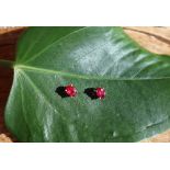 A pair of ruby earrings, of oval faceted form,