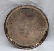 A George III silver waiter of circular form, with a line rim,