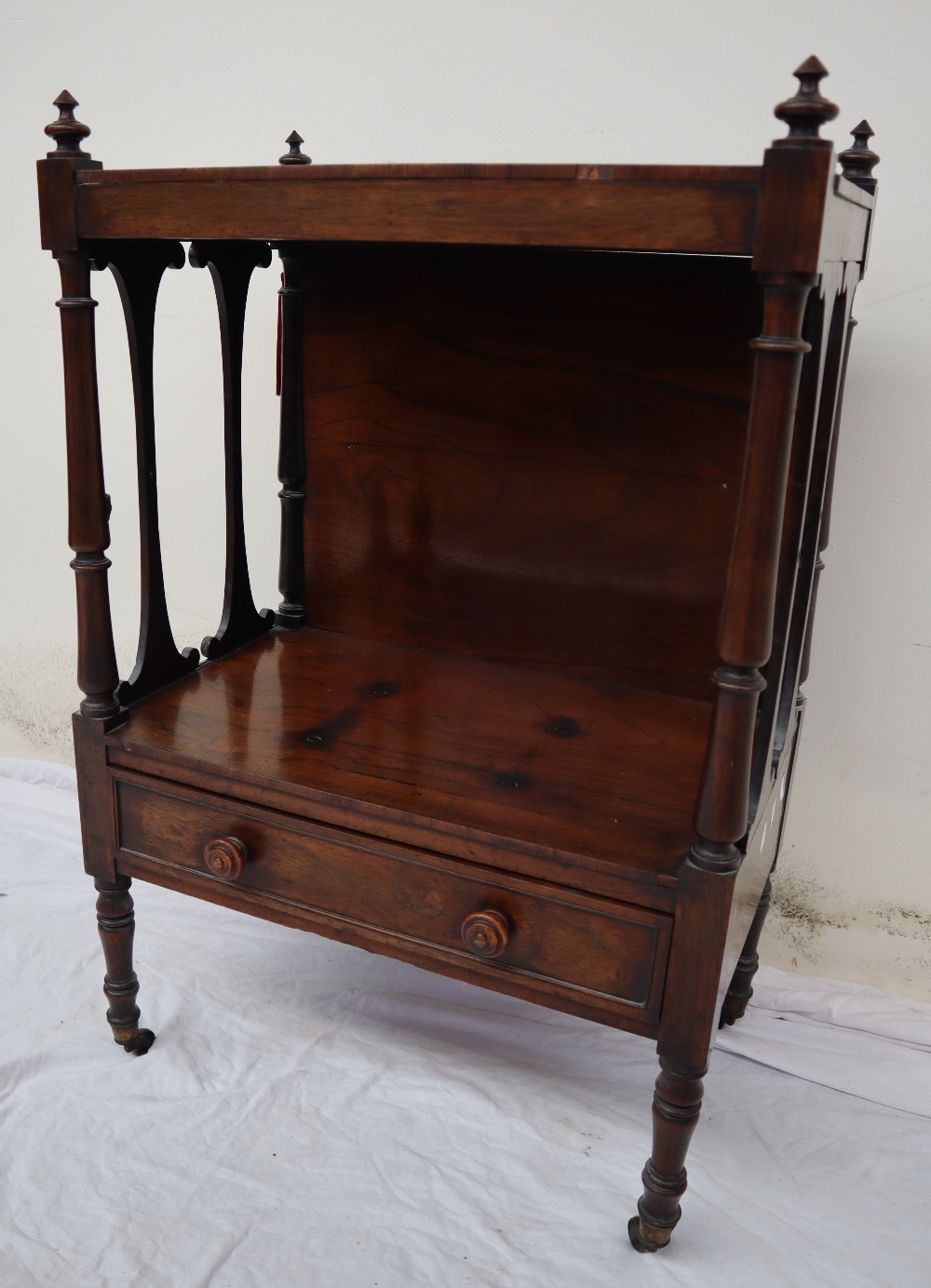 A Victorian rosewood whatnot, with a rectangular top and turned finials,