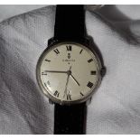 A Gentleman's Corum wristwatch, the white dial with Arabic numerals and date aperture at 6,