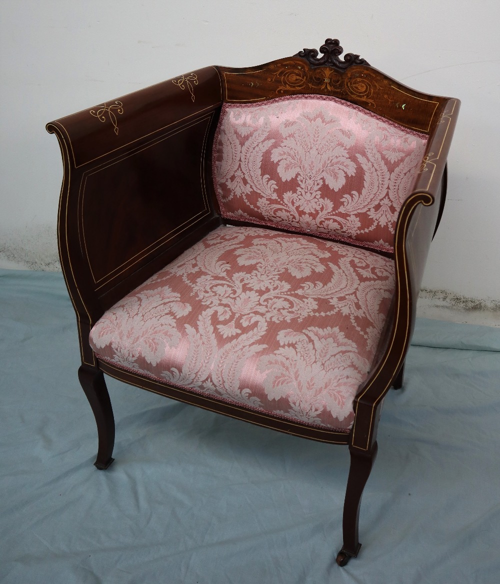 An Edwardian mahogany elbow chair, with a carved,