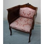 An Edwardian mahogany elbow chair, with a carved,