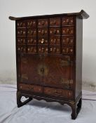 A Chinese brass bound hardwood medicine cabinet,