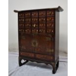 A Chinese brass bound hardwood medicine cabinet,