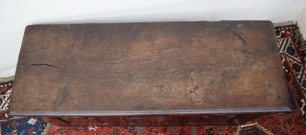 An 18th century oak coffer, the planked rectangular top above a three panelled front on stiles, - Image 3 of 5