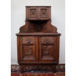 A 19th century carved oak Low Countries corner cabinet, with a pair of cupboard doors to the top,