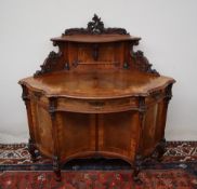 A 19th century French Walnut Lady's writing desk, with a raised carved cresting above a shelf,