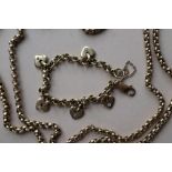 A 9ct yellow gold necklace and a 9ct gold bracelet with heart shaped charms,