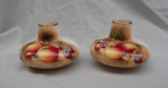 A pair of Royal Worcester bone china vases, of squat form painted with apples and cherries,