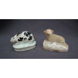 A 19th century Staffordshire pottery model of a crouching rabbit, on an oval base,