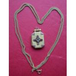 A yellow metal paste set locket of rectangular form with cut corners, marked 9,