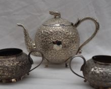 An Indian white metal matched three piece teaset, the teapot with an elephant finial,