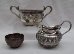 An Indian white metal twin handled sugar basin, with serpent handles,