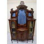 An Edwardian mahogany chiffonier, with a shaped back and three mirrors with shelves,